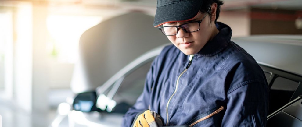Automotive technician inspecting a vehicle during service